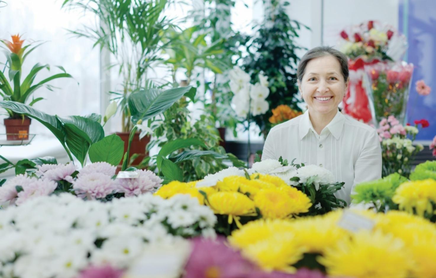 Modern floristry workspace with fresh flowers and design tools